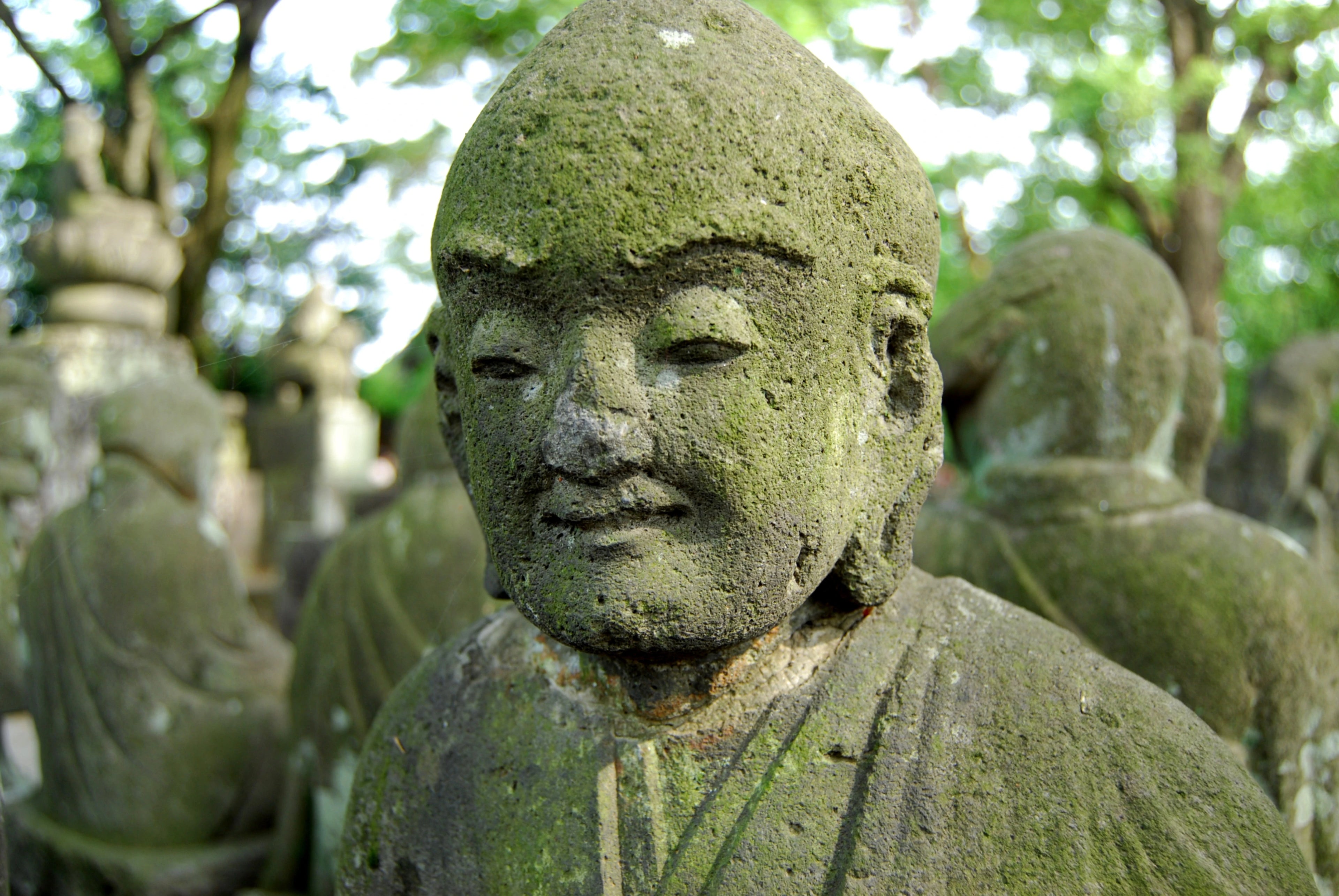 Serene stone Buddha statues in a traditional setting, reflecting cultural heritage in Kawagoe, Japan.